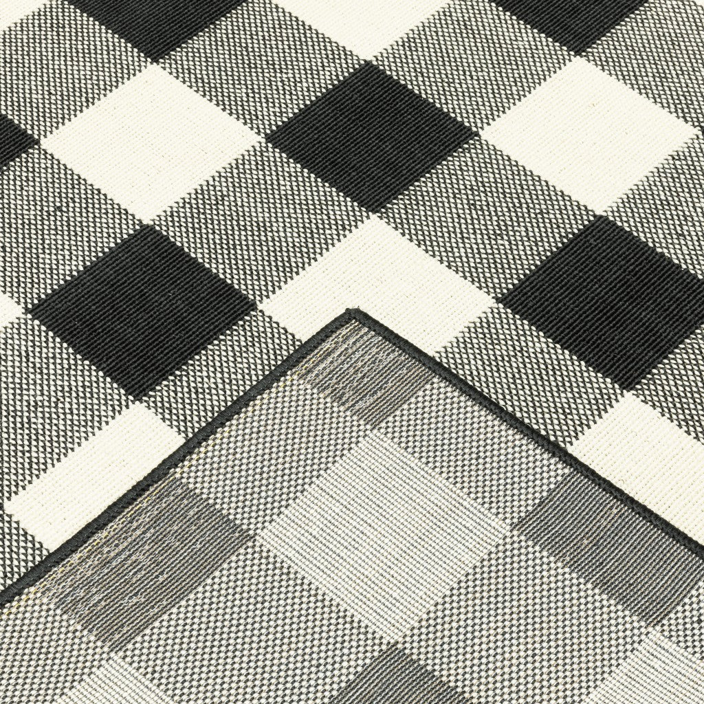 2' X 8' Black and Ivory Indoor Outdoor Area Rug