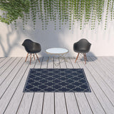 5' X 8' Blue and Ivory Geometric Stain Resistant Indoor Outdoor Area Rug