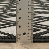 2' X 7' Beige and Black Geometric Stain Resistant Indoor Outdoor Area Rug