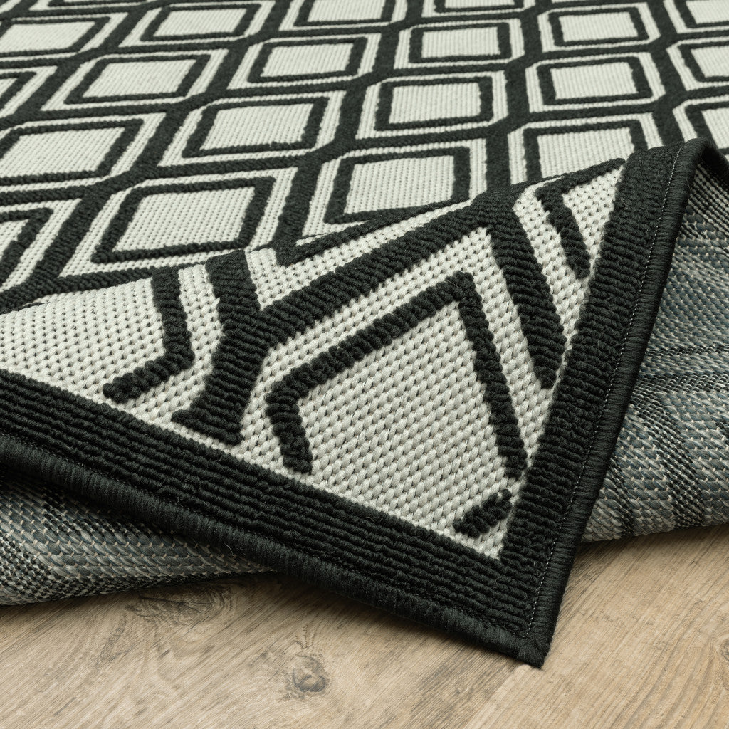 2' X 7' Beige and Black Geometric Stain Resistant Indoor Outdoor Area Rug