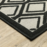 7' X 9' Beige and Black Geometric Stain Resistant Indoor Outdoor Area Rug