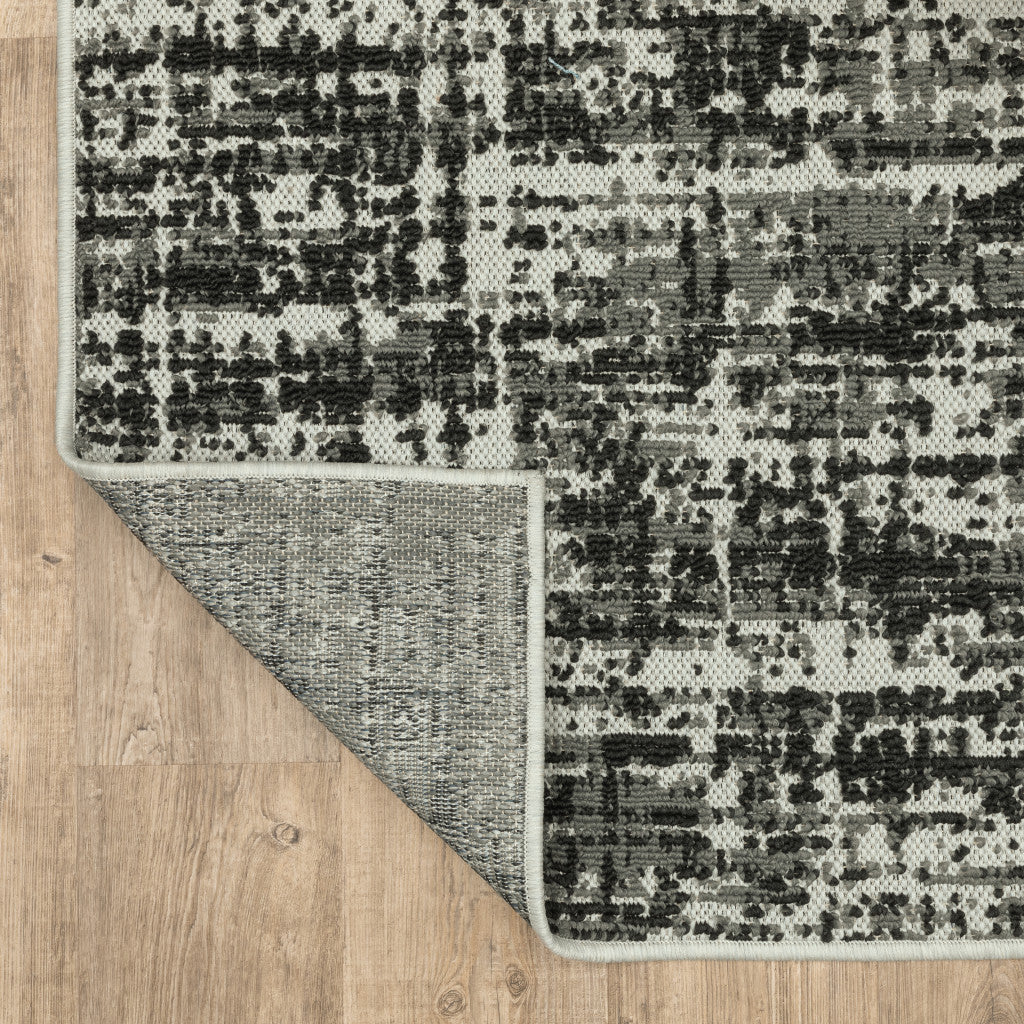 2' X 7' Beige and Black Abstract Stain Resistant Indoor Outdoor Area Rug