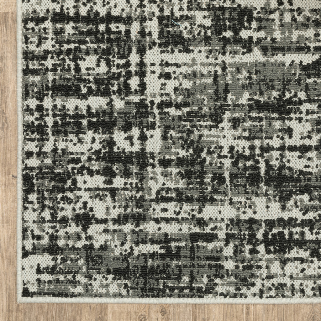 2' X 7' Beige and Black Abstract Stain Resistant Indoor Outdoor Area Rug