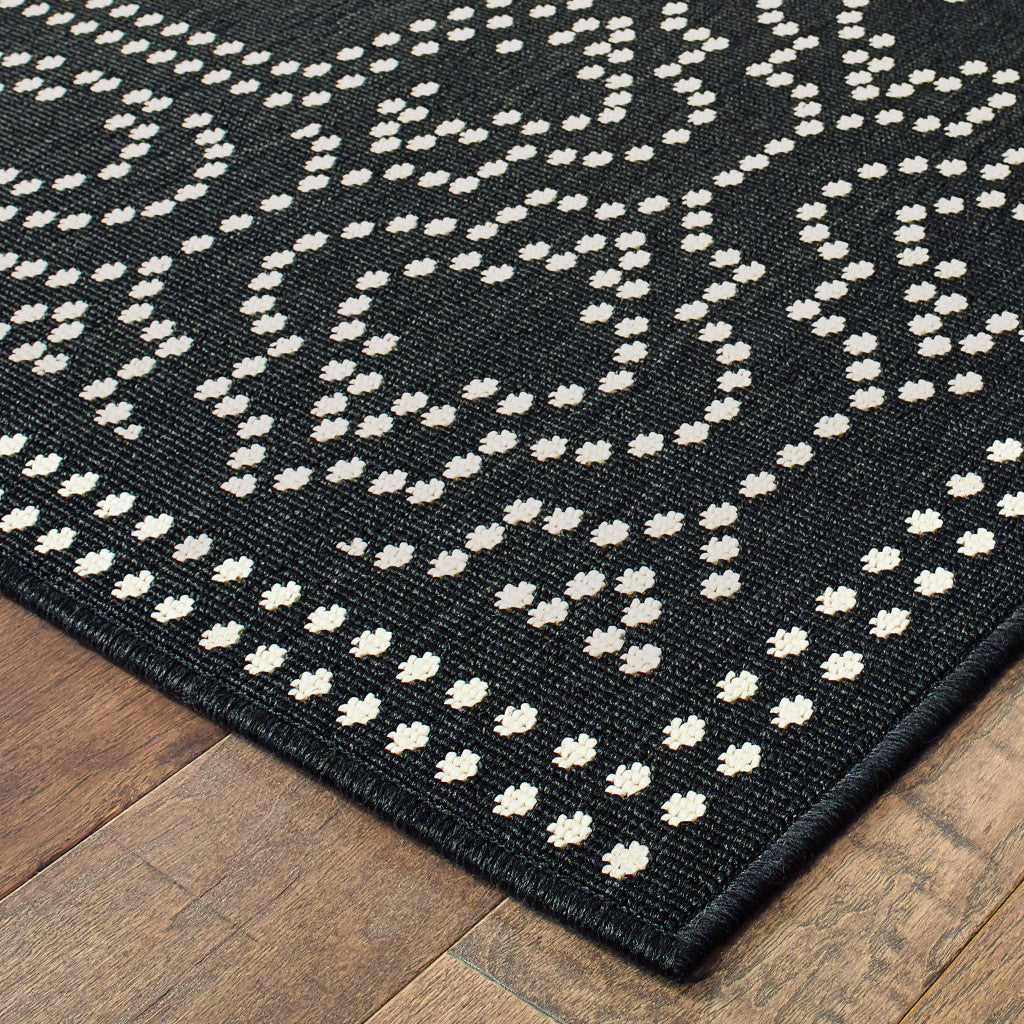 7' X 10' Black and Ivory Stain Resistant Indoor Outdoor Area Rug