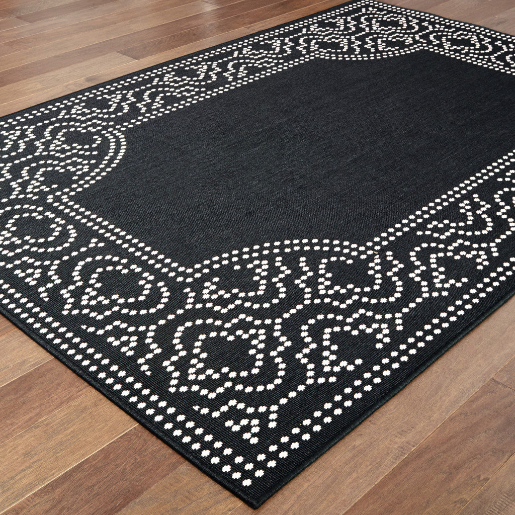 7' X 10' Black and Ivory Stain Resistant Indoor Outdoor Area Rug