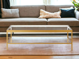 54" Clear And Gold Glass And Steel Coffee Table With Shelf