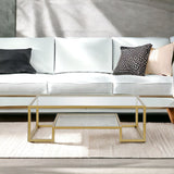 54" Clear And Gold Glass And Steel Coffee Table With Shelf